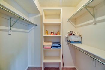 Walk in closet with shelves and a sink and a mirror at Hunt Club Apartments, Integrity Realty, Copley, 44321